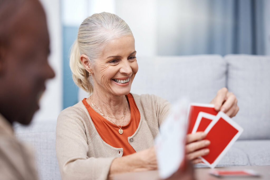 The Gardens at Quail Springs | Senior woman playing a game of cards