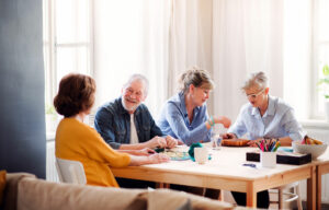 The Gardens at Quail Springs | Happy seniors playing board games together