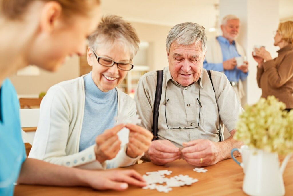 Gardens at Quail Springs | Happy seniors working on a puzzle