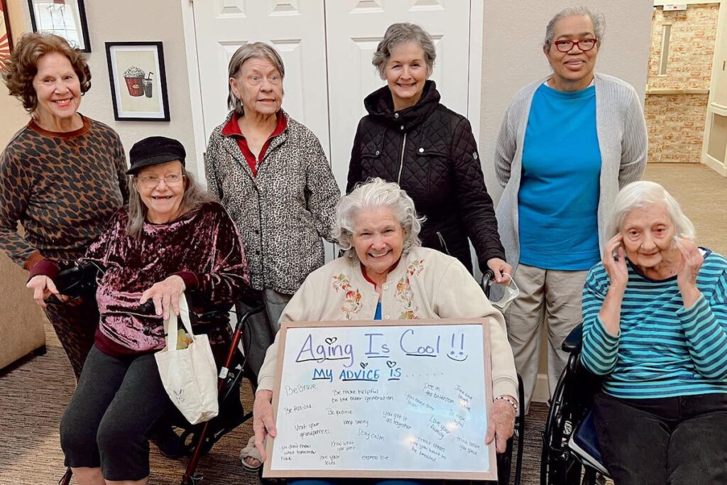 The Gardens at Quail Springs | Seniors holding a board showing their advice for getting older