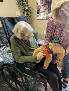 The Gardens at Quail Springs | Senior resident doing pet therapy