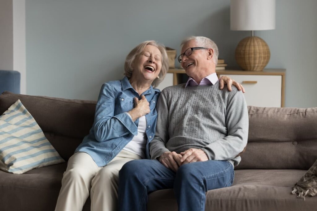 The Gardens at Quail Springs | Seniors Laughing On The Sofa